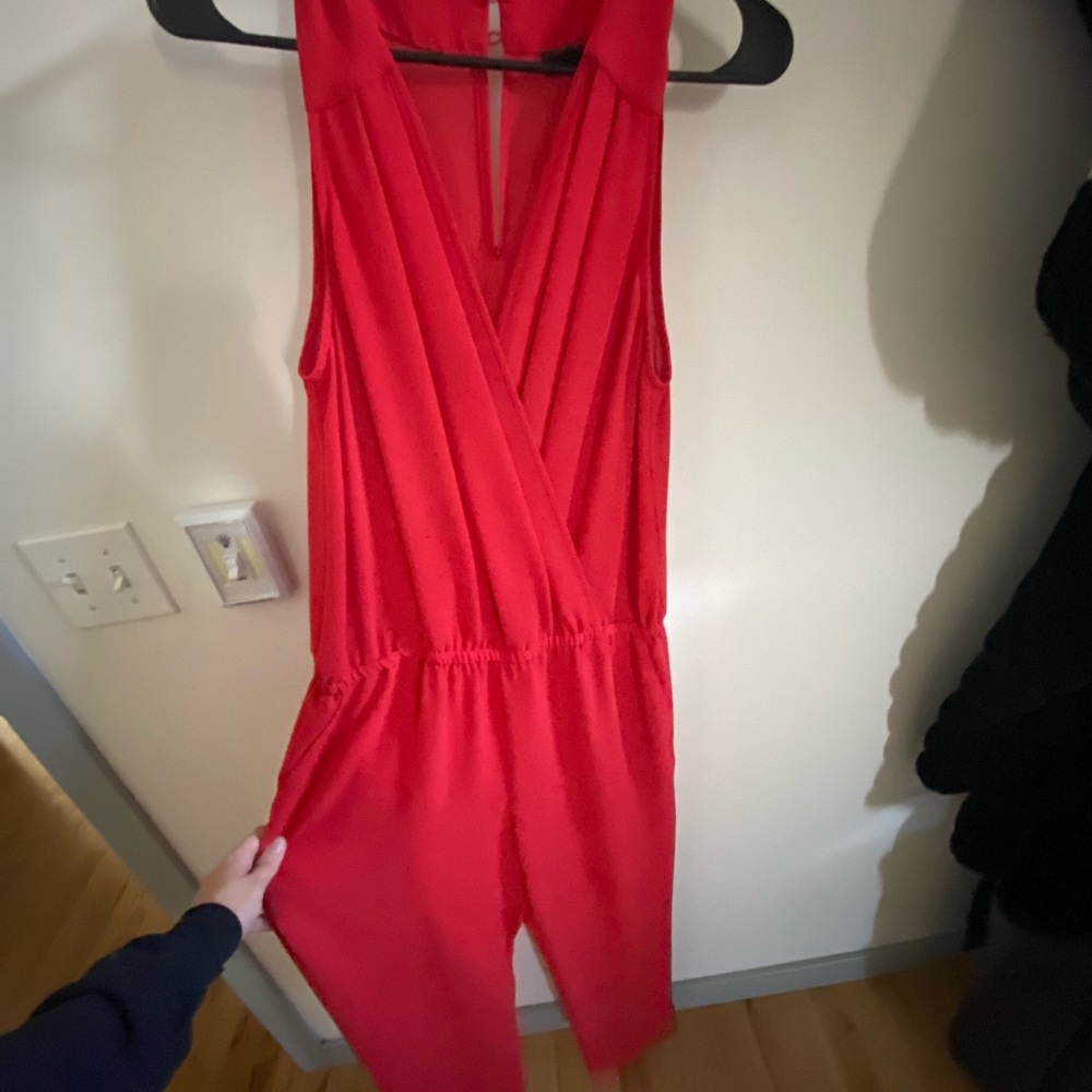 Red/orange V-neck  jumpsuit with chest coverage.